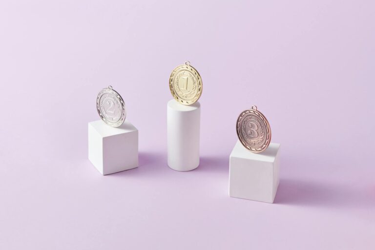 Three medals on podium blocks symbolizing first, second, and third place awards.