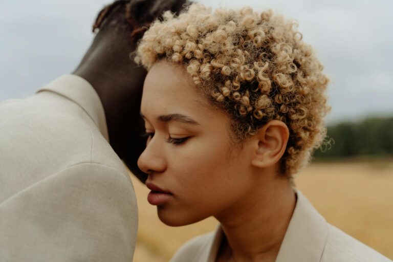Close-up of a couple embracing in a serene rural landscape, evoking a sense of intimacy and tranquility.