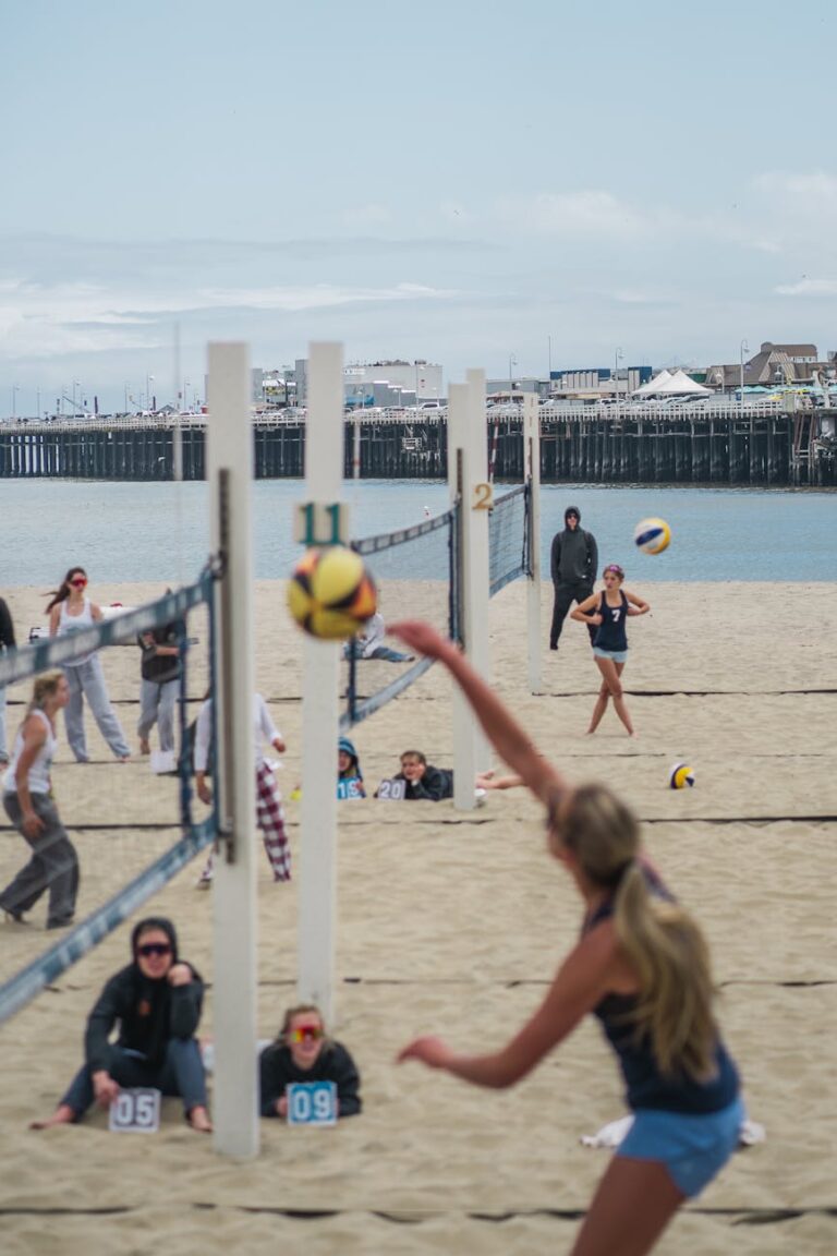 Exciting beach volleyball match with athletes playing in sunny Santa Cruz, California.