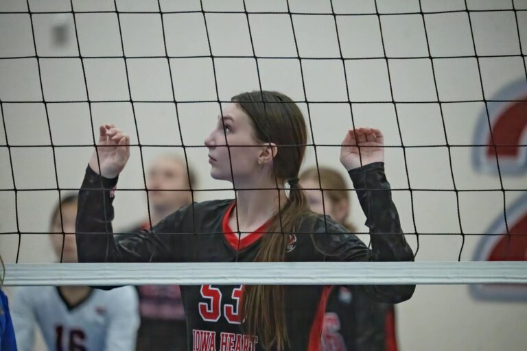 Young female volleyball player focused during an indoor match in Rochester, MN.