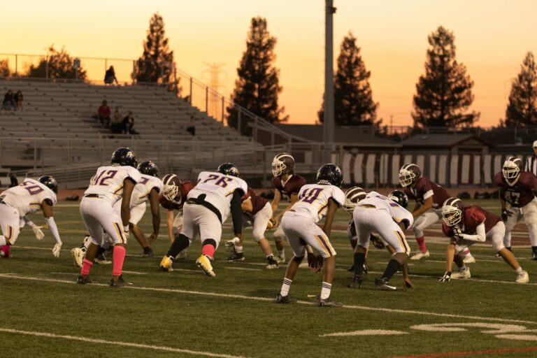 Intense American football game between two teams at sunset in Roseville, California.