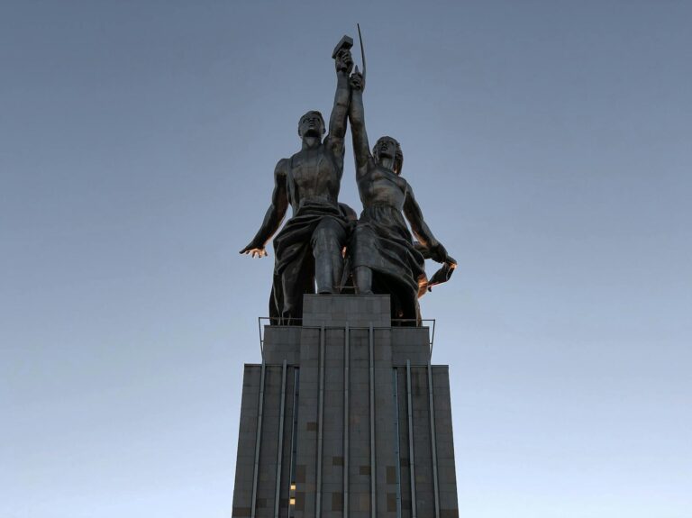 Iconic Worker and Kolkhoz Woman statue in Moscow, captured at dusk with a clear blue sky.