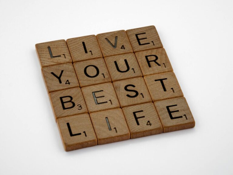 Scrabble tiles arranged to spell 'Live Your Best Life' on a white background.