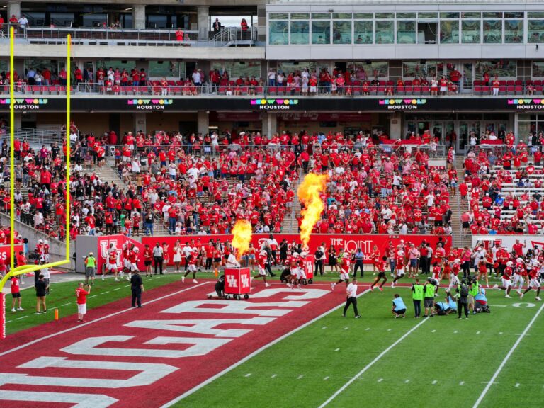 Houston college football match with vibrant crowd and fire effects. Captures the sports spirit.