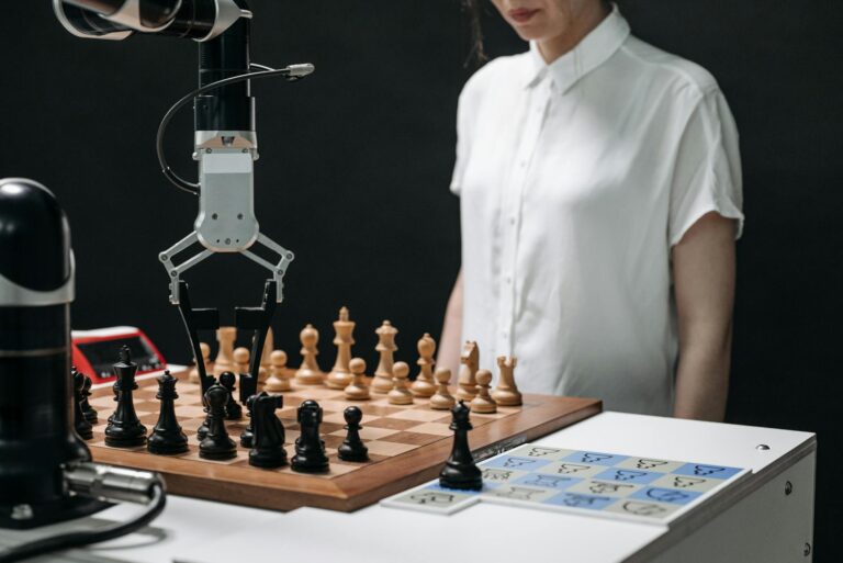 A robotic arm and a person engaged in a strategic chess match on a chessboard.