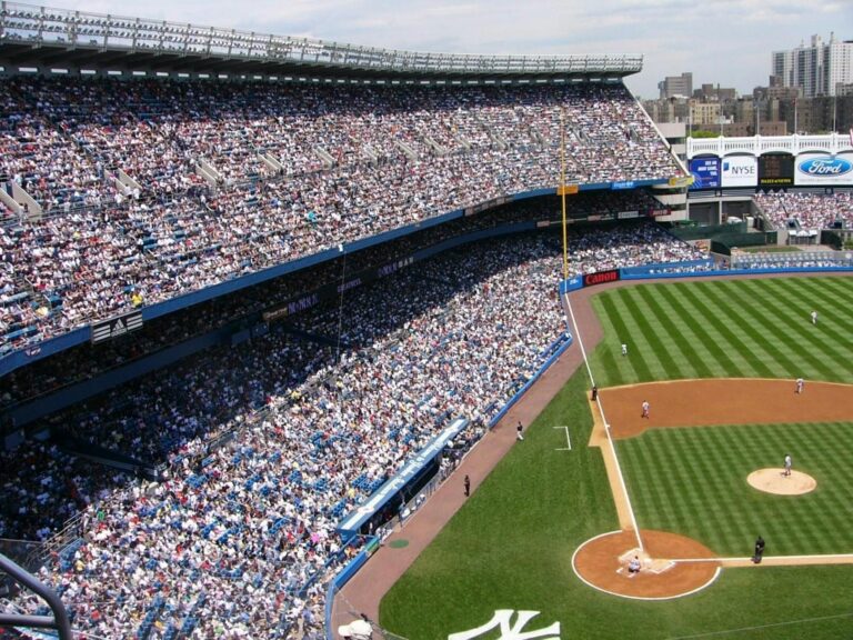 Aerial view of a crowded baseball stadium during a live game.