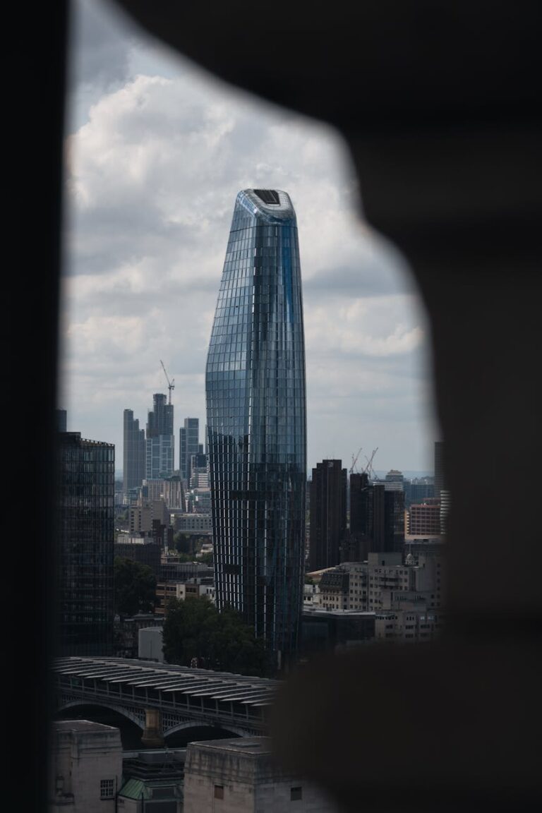 Stunning view of a modern skyscraper in London's skyline with an overcast sky.