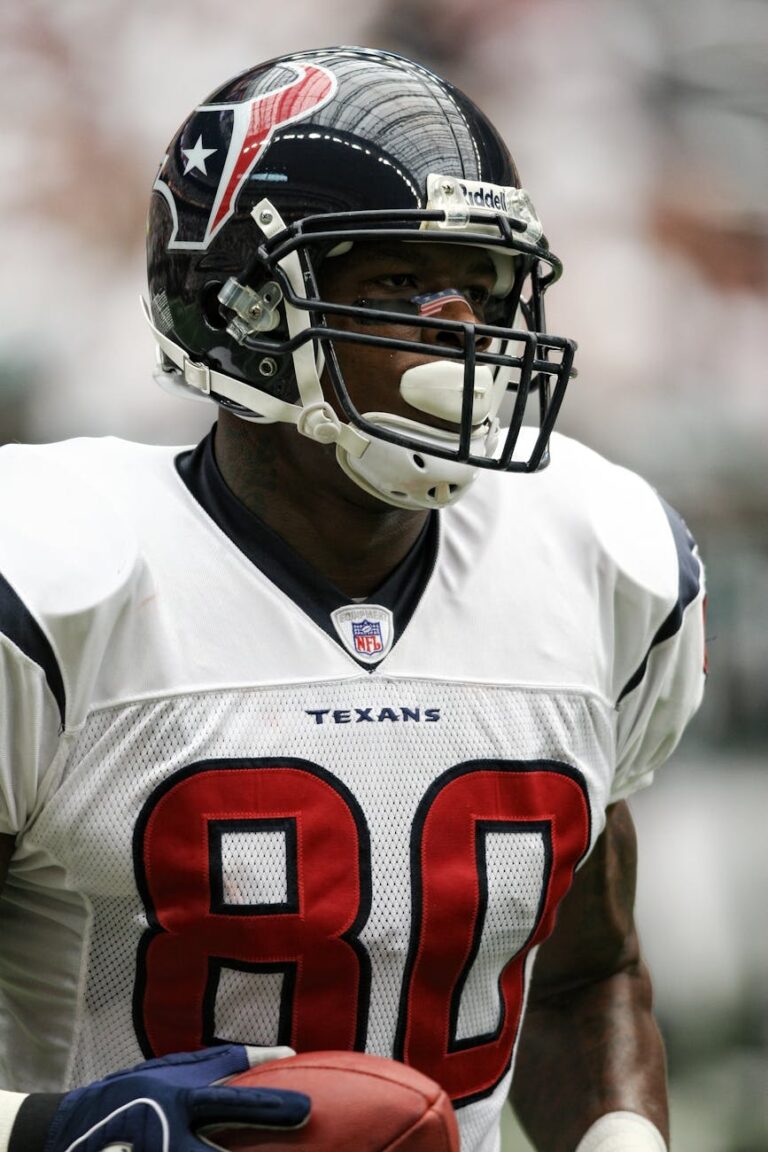Close-up of an American football player during a game, showcasing determination.