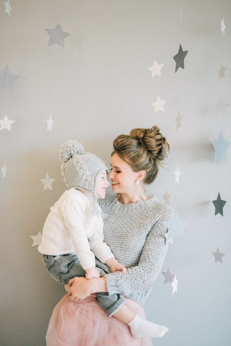 A mother lovingly embraces her child in a playful indoor setting with star decorations.