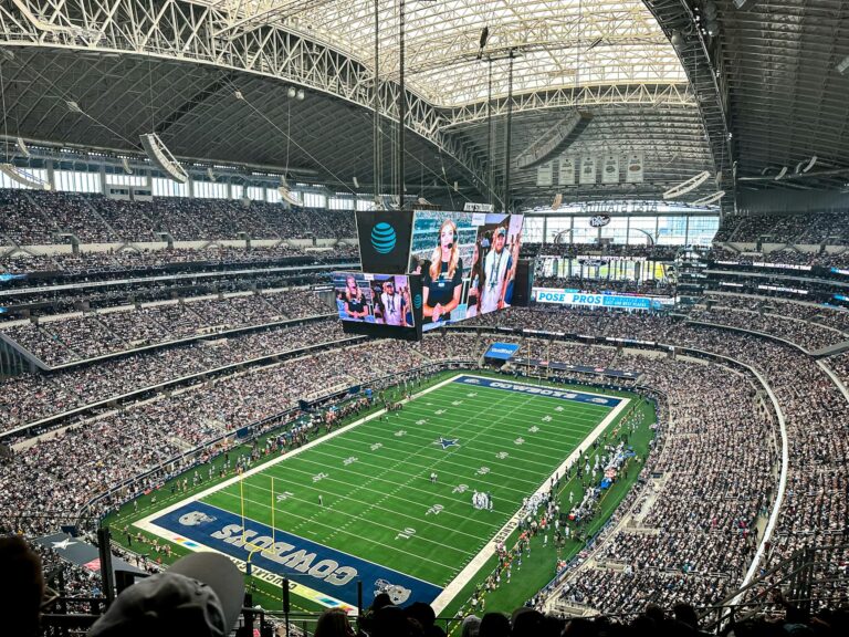 A packed AT&T Stadium in Arlington, Texas, showcasing a thrilling football game with enthusiastic fans.