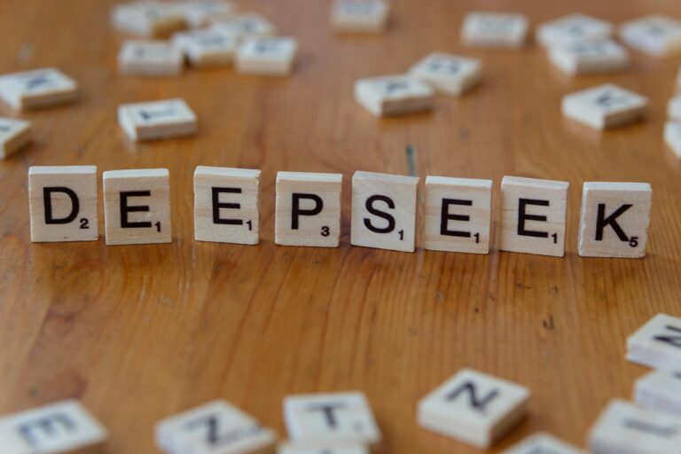 Scrabble tiles spelling 'DeepSeek' on a wooden surface. Perfect for AI and tech themes.