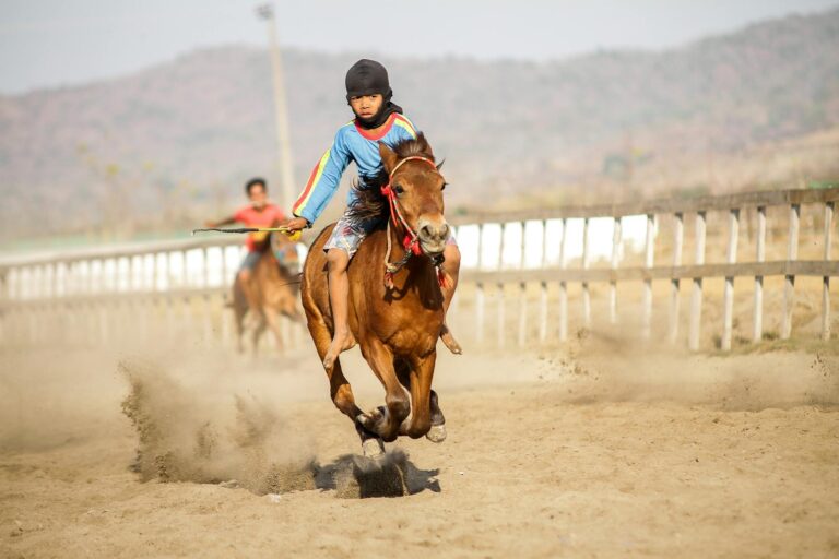 A young rider competes in a horse race on a sunny day in Jakarta, Indonesia.