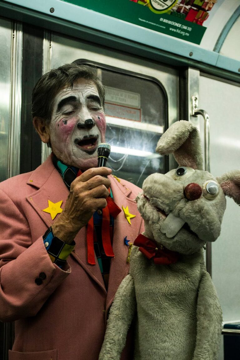 Clown in pink suit performing with a bunny puppet on Mexico City metro.