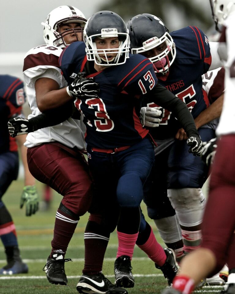 Athletes in dynamic play during a competitive football game.