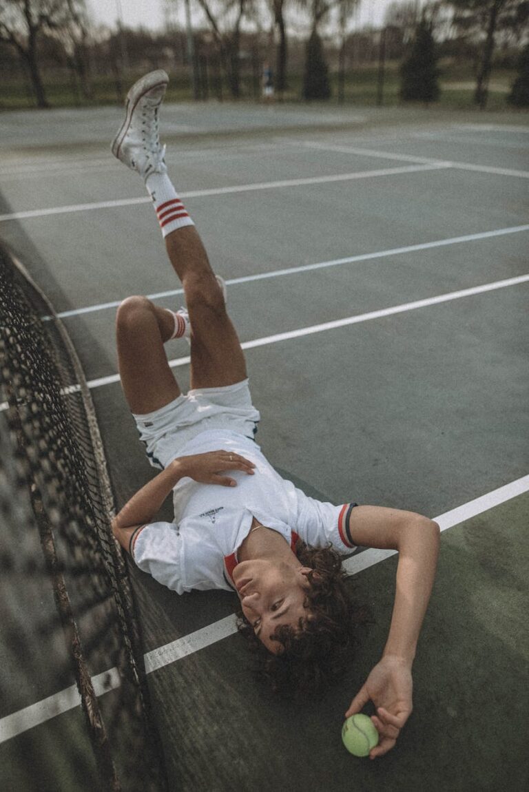 Teen tennis player in casual pose on outdoor court, capturing pre-game moments.