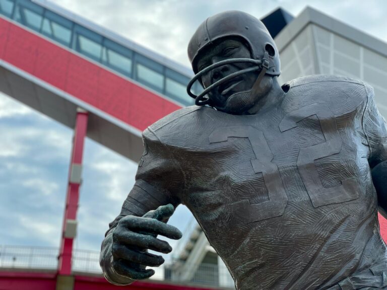 Close-up of a football player statue outside a modern stadium in Cleveland, Ohio.