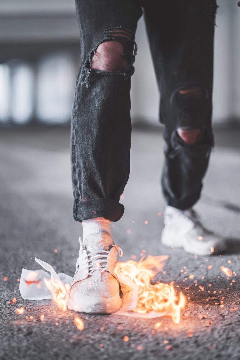 Stylish sneakers ignited in flames highlight urban fashion and daring style.