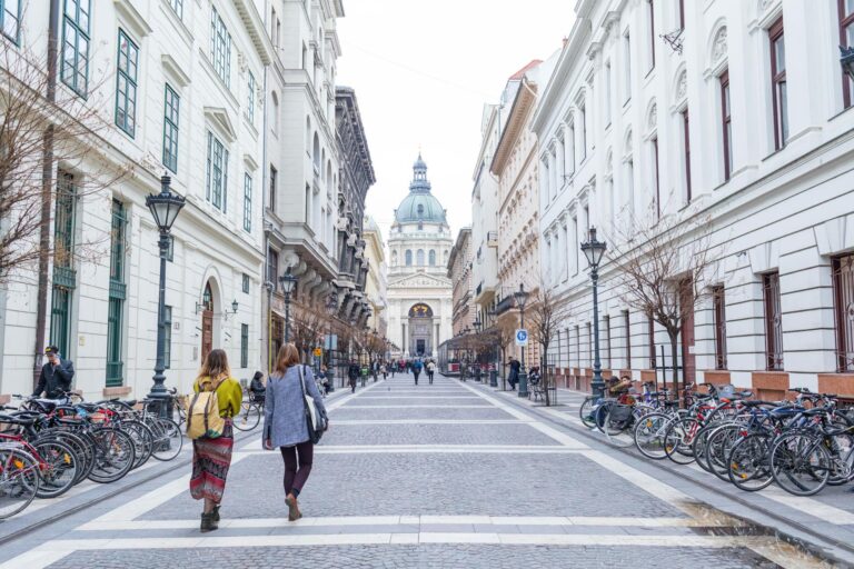 Pedestrian street leading to St. Stephen's Basilica in Budapest, featuring urban architecture.