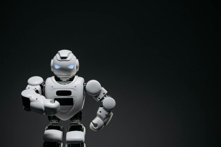 A sleek white robot showcasing modern robotics technology against a dark backdrop.