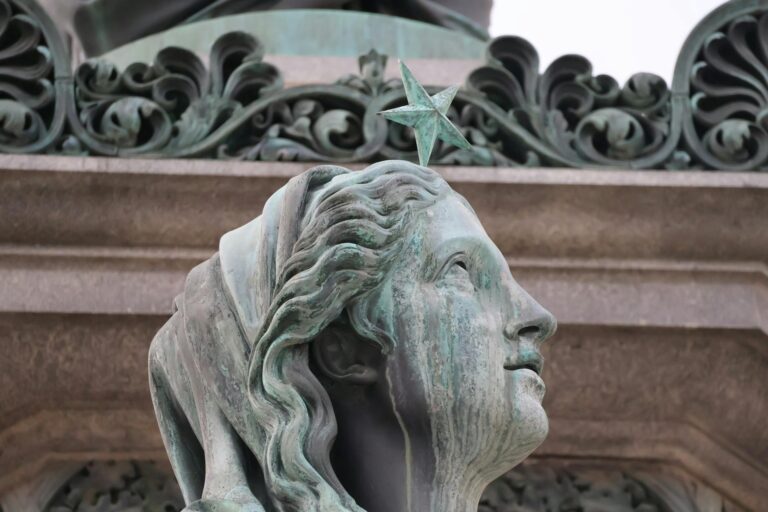 Close-up shot of a historic statue displaying intricate details and a star symbol.