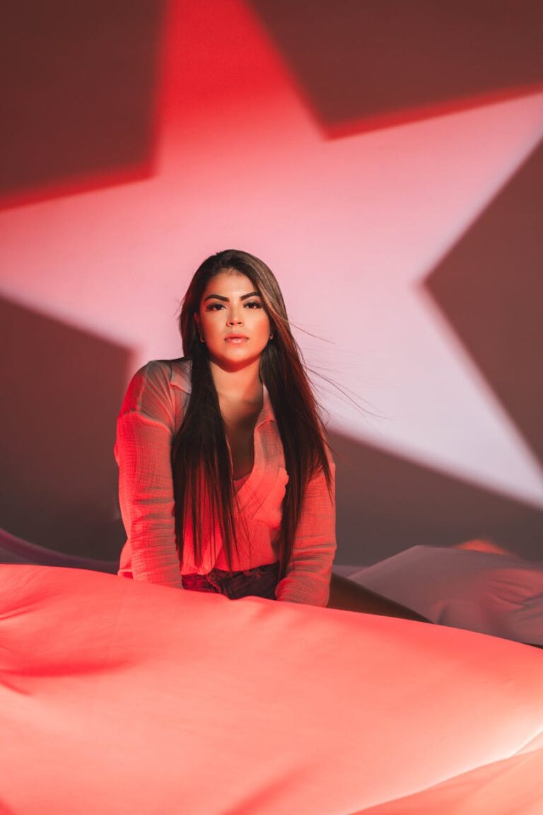 Captivating portrait of a woman with red star lighting, creating a dramatic and artistic mood.