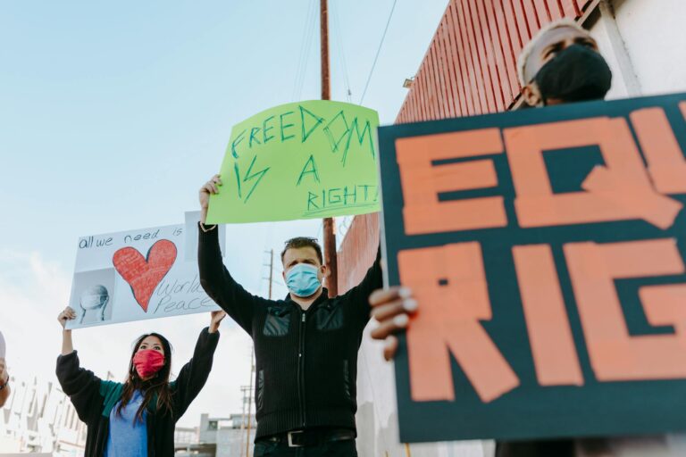 Activists holding signs for freedom and equality during a peaceful protest.