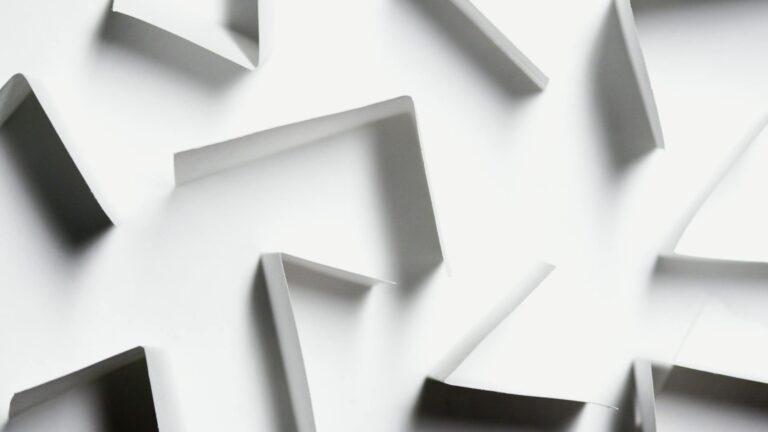 Abstract white paper shapes creating a modern geometric design with shadows.