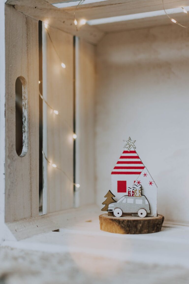 A charming Christmas decoration with tiny house and car in a wooden box.
