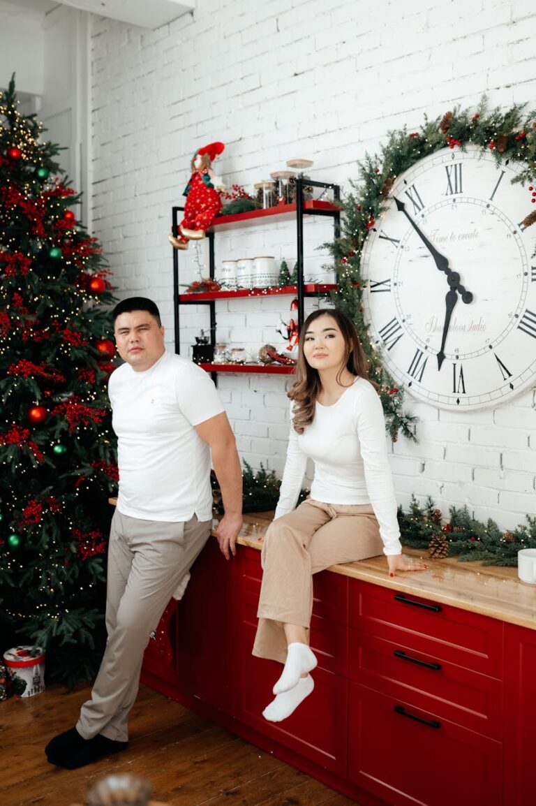 A couple enjoying festive time at home with holiday decor and a Christmas tree.