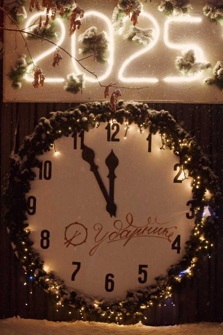 Large decorative clock at midnight with 2025 sign and festive lights in Saratov, Russia.