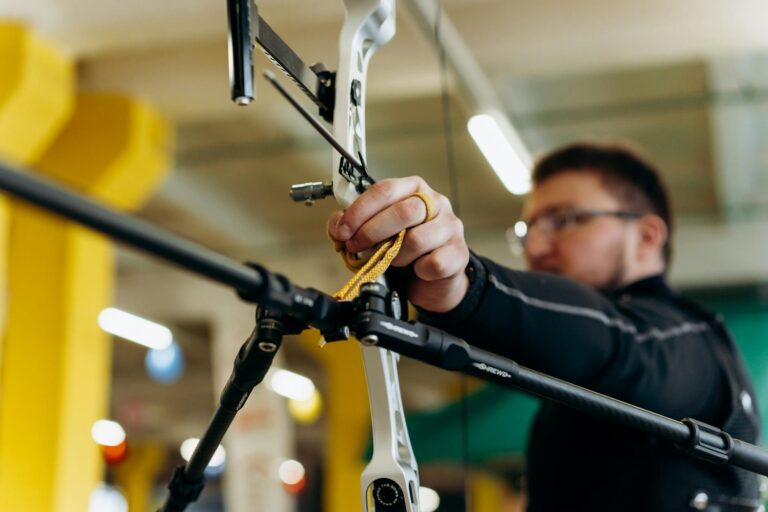 A determined archer aiming with precision indoors. Captured in dynamic detail.