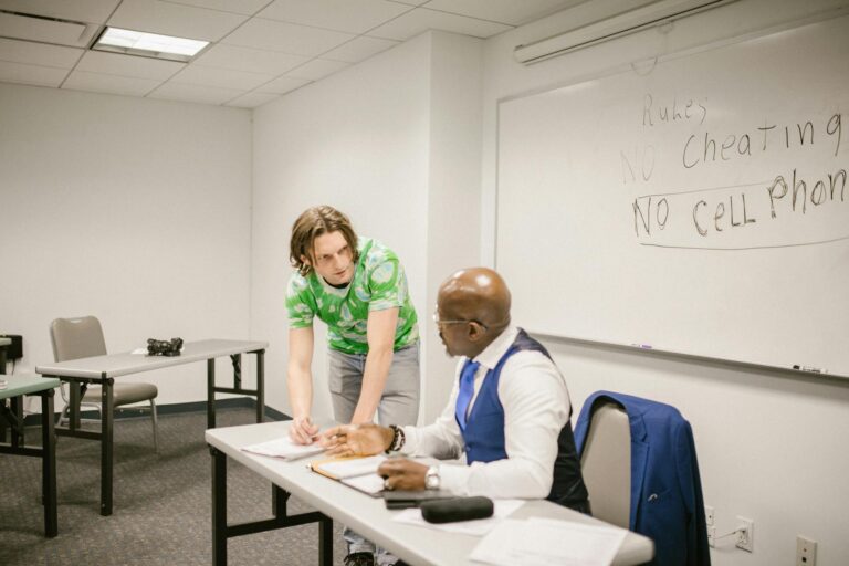 A teacher and student discuss exam rules in a modern classroom setting.