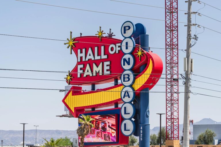 Vibrant sign of the Pinball Hall of Fame in Las Vegas, Nevada, captured outdoors in daylight.