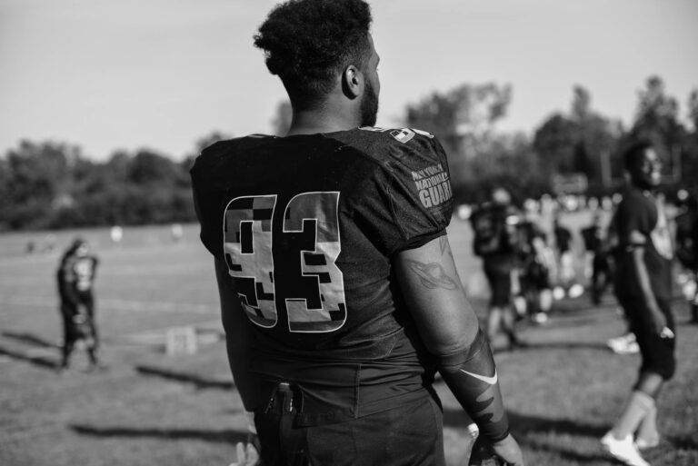Black and white image of a football player wearing jersey number 93 during a game day.