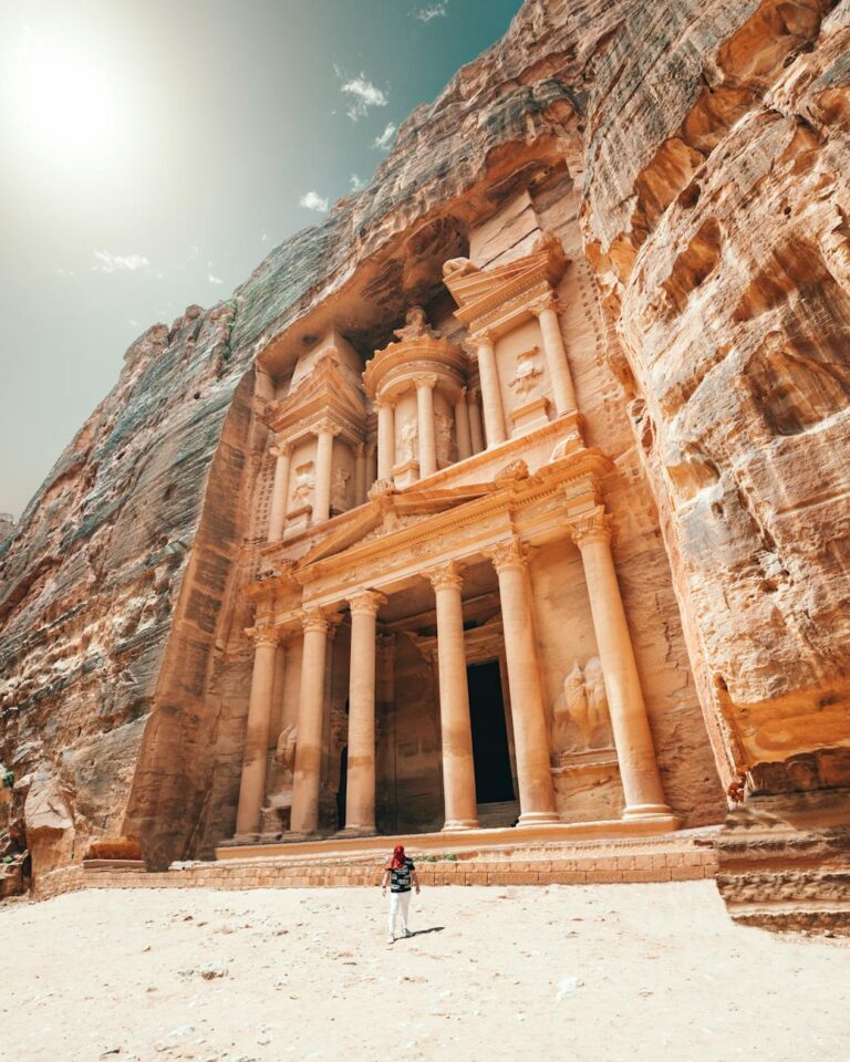 Explore Petra's iconic Treasury in bright sunlight, a symbol of ancient Jordanian architecture and history.