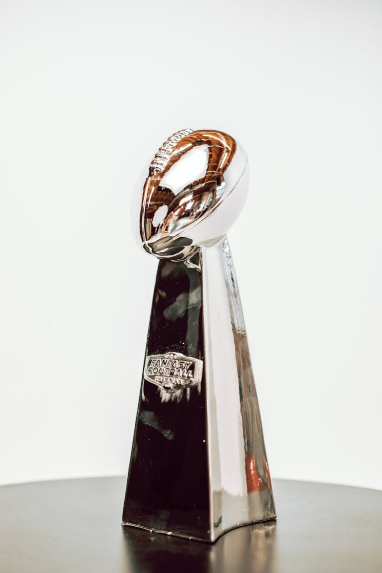 Sleek silver football trophy with shiny finish, perfect for sports achievements.