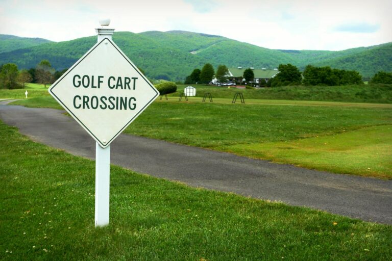 A picturesque view of a golf course in Crozet, Virginia featuring a "Golf Cart Crossing" sign.