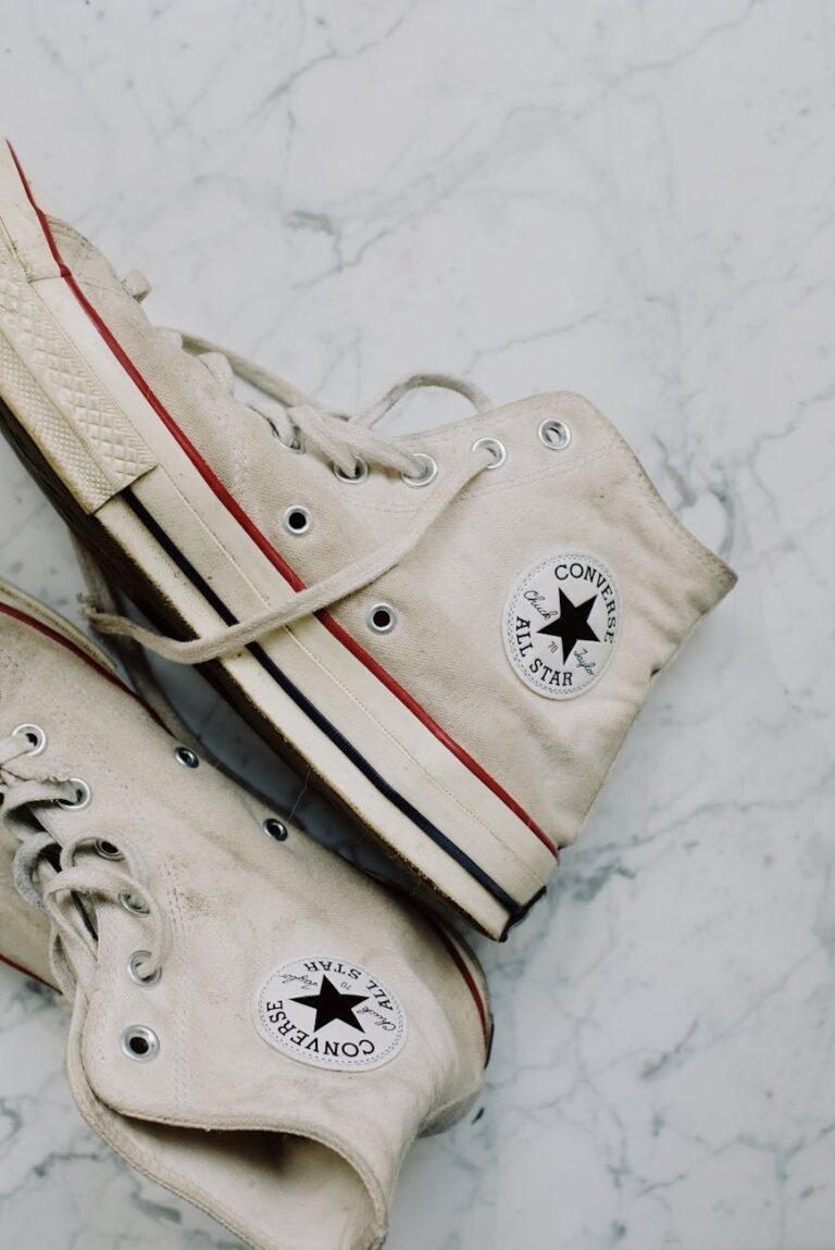 Classic Converse All Star sneakers on a marble surface with a retro vibe.