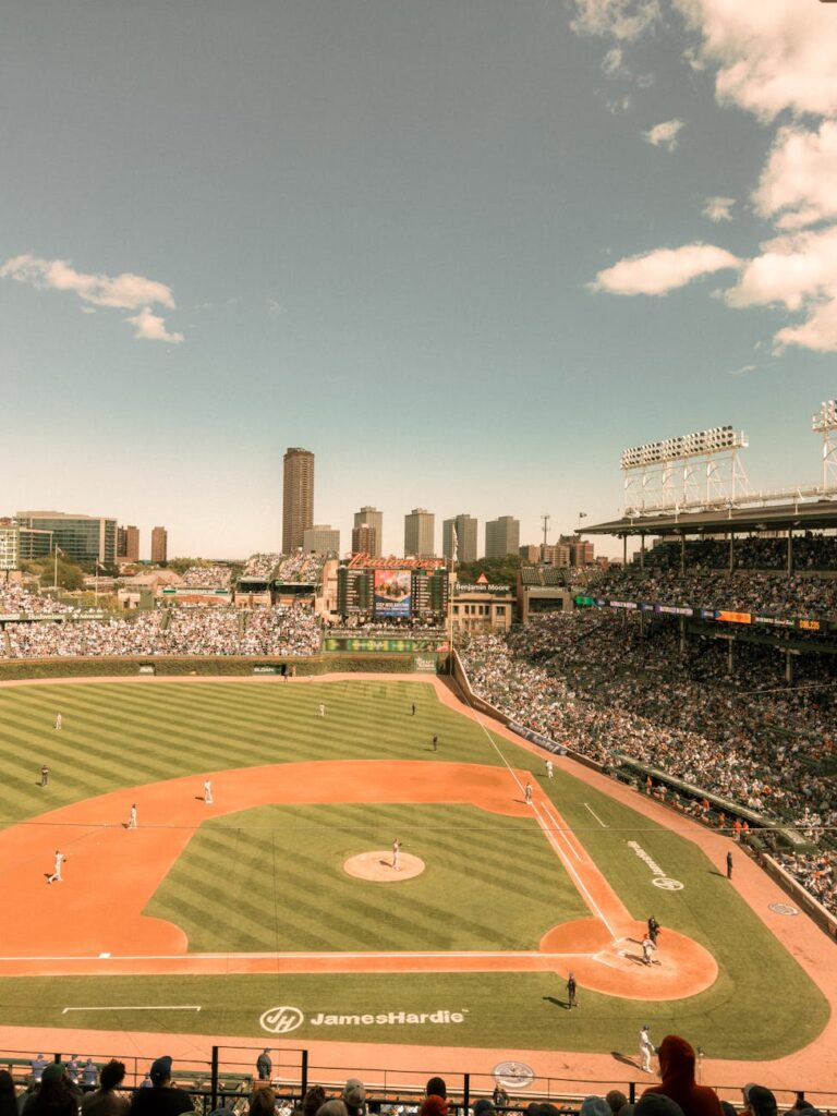A vibrant baseball game in progress at a renowned city stadium with a packed audience and scenic skyline.