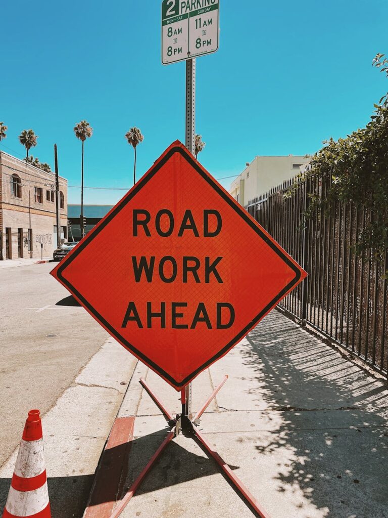 Clear and vibrant road work sign on a sunny Los Angeles street, ensuring safety and awareness.