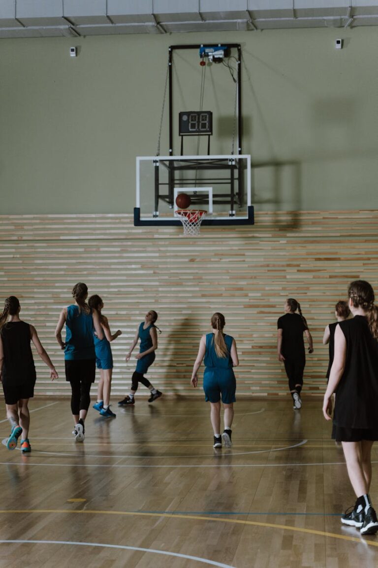 Group of women basketball players practicing on an indoor court.