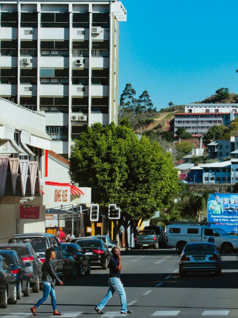 A vibrant street in Manzini, Eswatini, showcasing daily life with pedestrians and traffic.