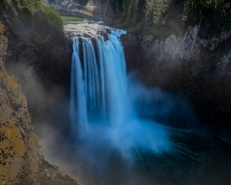 Stunning view of Snoqualmie Falls cascading in a lush Washington forest.